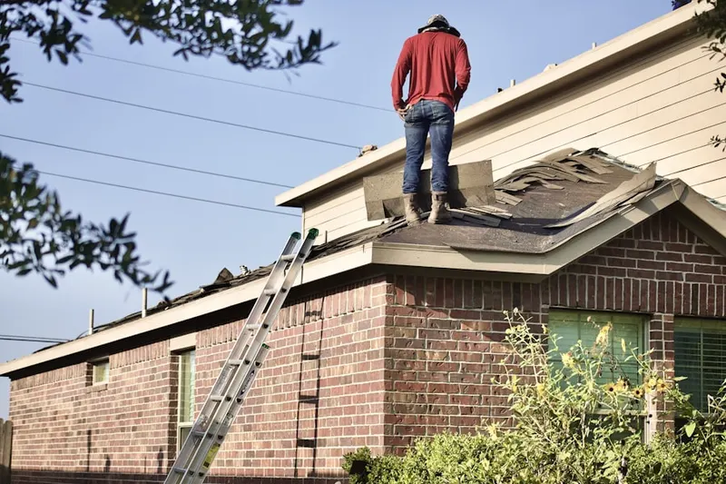 Professional roofer working on a residential roof in The Ohio State University